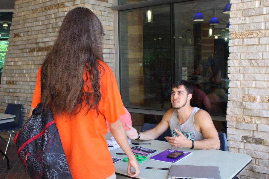 Zach Barrett, a senior exercise science major, speaks with a potential freshman recruit about joining Lambda Chi Alpha.