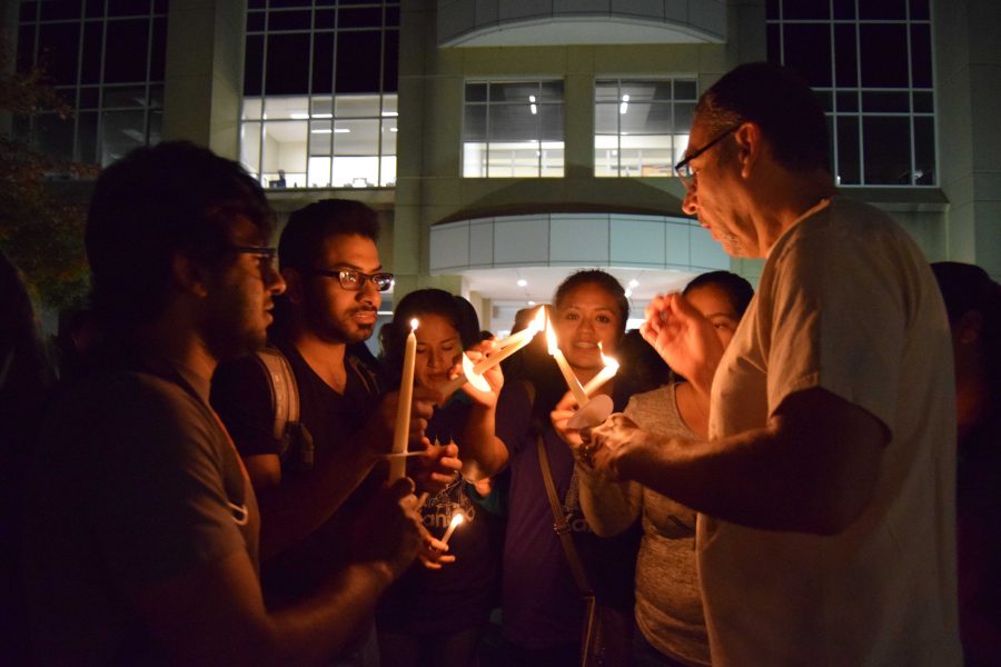 Spanish professor Manuel Apodaca-Valdez shares the flame of his candle with attendees at the university’s celebration of the Day of the Dead. Apodaca-Valdez led students, faculty and visitors in a candlelight walk in front of the Liberal Arts Building, signifying the transition from life to the afterlife. The Day of the Dead celebration, put on by Student Government Association, Spanish Club and the Hispanic Student Union, has had about 100 attendees in past years.