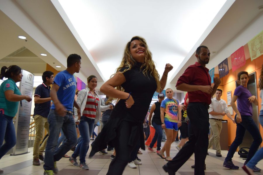 Local dance instructor Heidi Garza leads attendees at the university’s Day of the Dead celebration in a salsa dance. The annual event featured Garza’s Latin dance lessons as a new component of the three-hour celebration in the Liberal Arts Building.