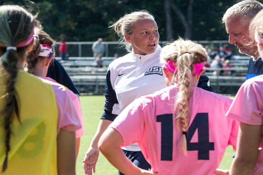 Women’s head soccer coach Krissy Engelbrecht informs her players of the next play during the Kick for the Cure game in October.  Engelbrecht announced her resignation after 13 years as the head coach.  