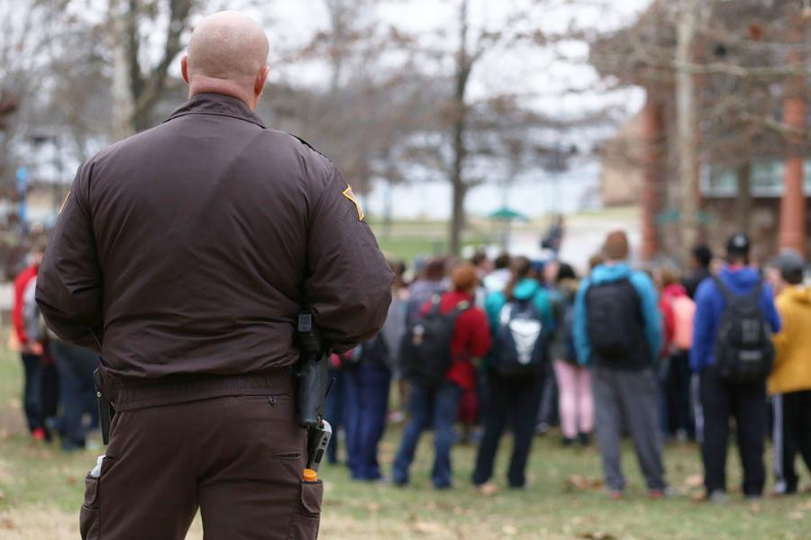 Sheriff Jason King watches over the students gathered in the Free Speech Zone during the Campus Ministry USA’s demonstration Monday. King said he wasn’t asked to go watch over the event, but felt “they might need me out here.” 
