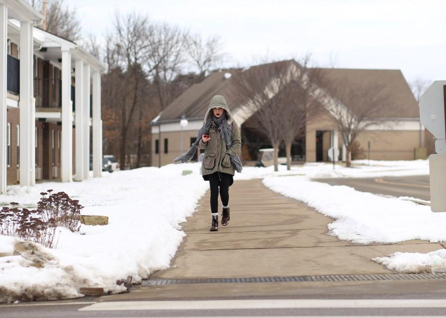 Sophomore art major Theanoe Christos bundles up as she walks to class from the campus apartments Monday morning. The university was closed Friday because of weather conditions.