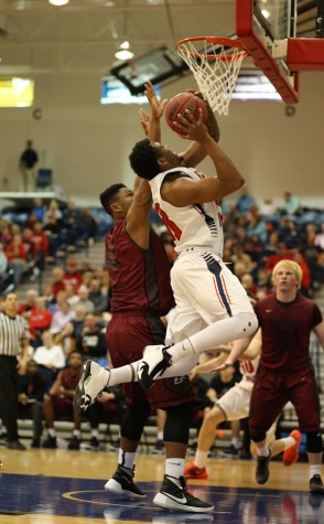 Junior forward T.J. Tisdell shoots for two during the first half of the men’s basketball game against University of Indianapolis Thursday in the PAC. UIndy won the game with a score of 82-78. 