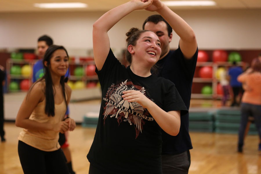 Richard Schuler, a senior engineering major, spins dance partner Dakota Fleetwood, a junior psychology major, as Paola Marizan, the student instructor of the Latin Dance Class that takes place Mondays and Thursdays in the RFWC, gives them pointers. 