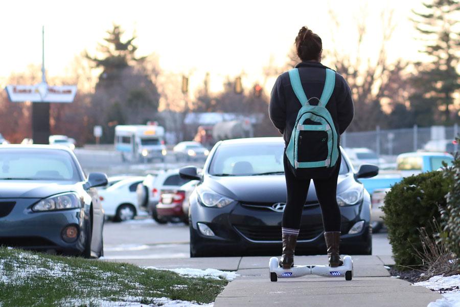 Erin Dobson, a junior public relations and advertising major, rides on her hoverboard given to her for Christmas in the parking lot of Eagle Village apartments Tuesday. Dobson just uses hers around her apartment due to the current ban of the scooters on campus. 