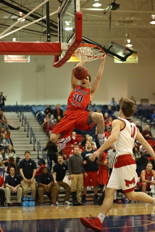 Freshman forward Jacob Norman dunks during the second half of the men’s basketball game against Maryville University in the PAC Thursday. Maryville won 89-80.