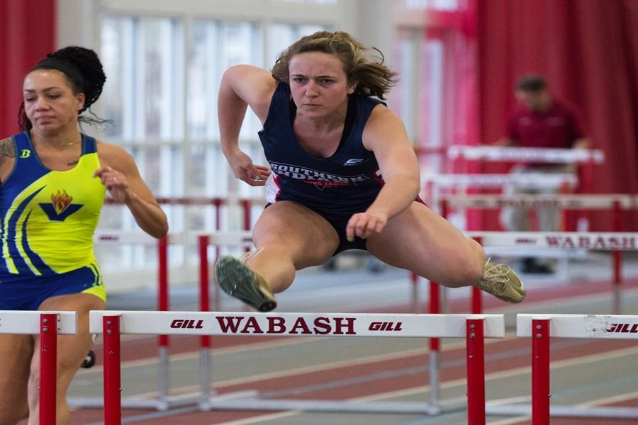Sophomore sprinter Jenna Martin clears a hurdle at the University of Indianapolis Collegiate Invitational January 23. Martin set a new school record in the 60-meter hurdles two meets later. 