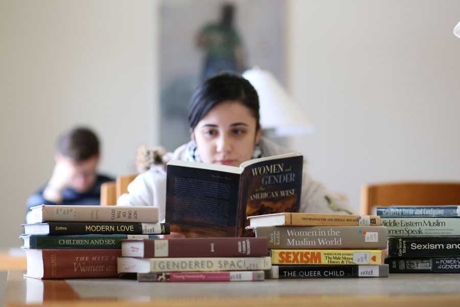 Deena Bregheith, a junior international student, looks through books about gender and sexuality Tuesday in Rice Library. Bregheith wants to learn more about these subjects while in the U.S. because her home country, Palestine, does not offer such education. 