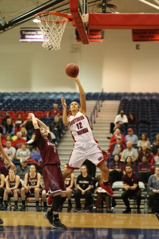 Junior forward Tasia Brewer shoots for two during the first half of the women’s basketball game against Bellarmine University Thursday in the PAC. The Eagles lost with a score of 59-87. 