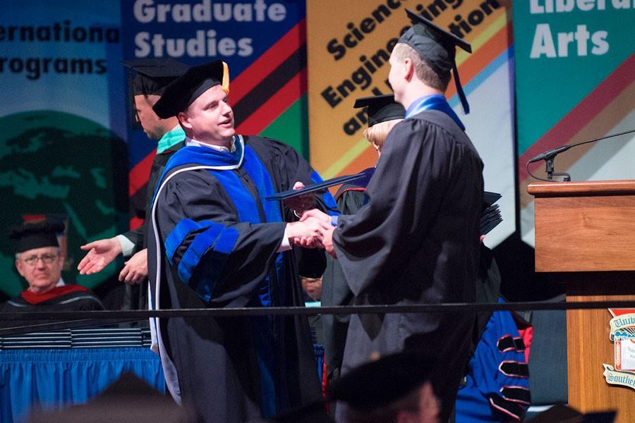 Scott Gordon, Dean of the Pott College of Science, Engineering, and Education, hands a diploma to a student at the 2015 Spring commencement. Gordon recently accepted an invitation to serve as the Eastern Washington University’s provost and vice president for academic affairs.
