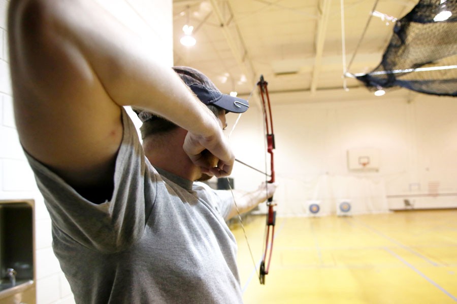 Senior engineering major Zach Clem aims his arrow during Archery Club practice March 2, at the Physical Activities Center.