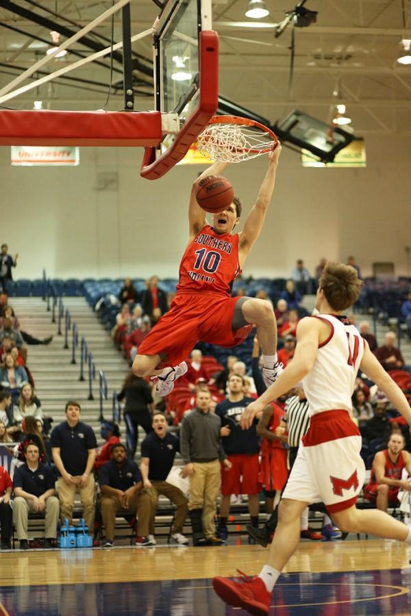 Freshman forward Jacob Norman dunks during the second half of the men’s basketball game against Maryville University in the PAC.