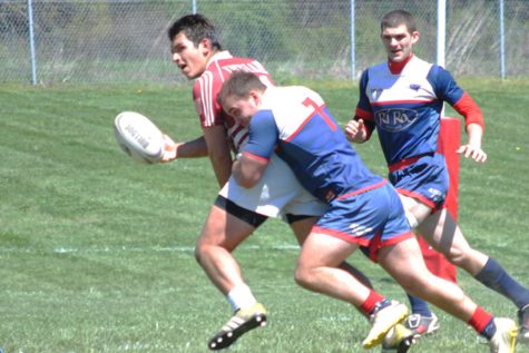 Flanker Ray Van tackles a member of the Indiana University rugby team during a game Saturday on the USI rugby pitch. USI’s rugby team will compete in nationals April 30 and May 1 in Colorado. 