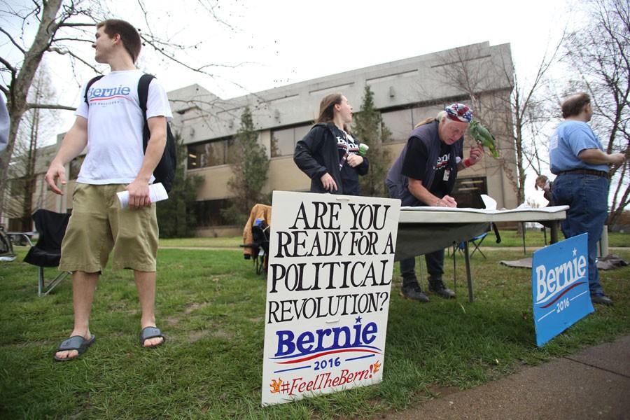 Students and volunteers ask passersby if they have registered to vote during a Bernie Sanders rally Thursday in the Free Speech Zone. Although the group was told they were not allowed to do voter registration by the Dean of Students Office, the volunteers still handed out information about where and how to register. 