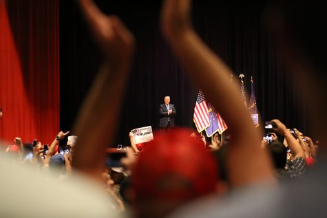 Republican presidential candidate Donald Trump takes to the stage as many supporters stand and welcome him Thursday at the Old National Events Plaza in Downtown Evansville. 