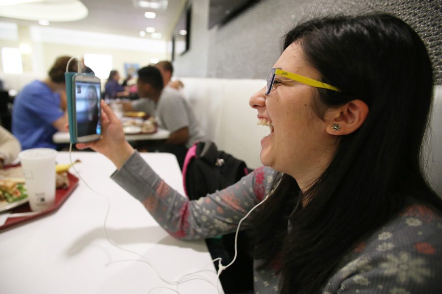 Junior English major Deena Bregheith laughs with Raheil Inaim, a childhood friend, on FaceTime Tuesday at The Loft. Inaim grew up with Bregheith in Palestine but moved to Canada after high school and they only see each other when Inaim visits her home country.