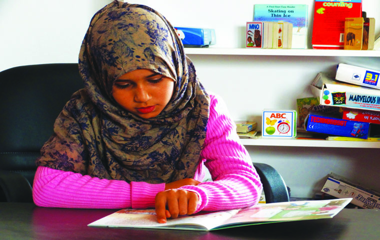 A student studies at her school  library which was paid for by Road to Mafraq. The donations which funded the project were largely from the Evansville community. Elizabeth Riedford, an organizer for “Run for Refugees,” said the girl told her her dream was to work hard to “become just like her teacher.”