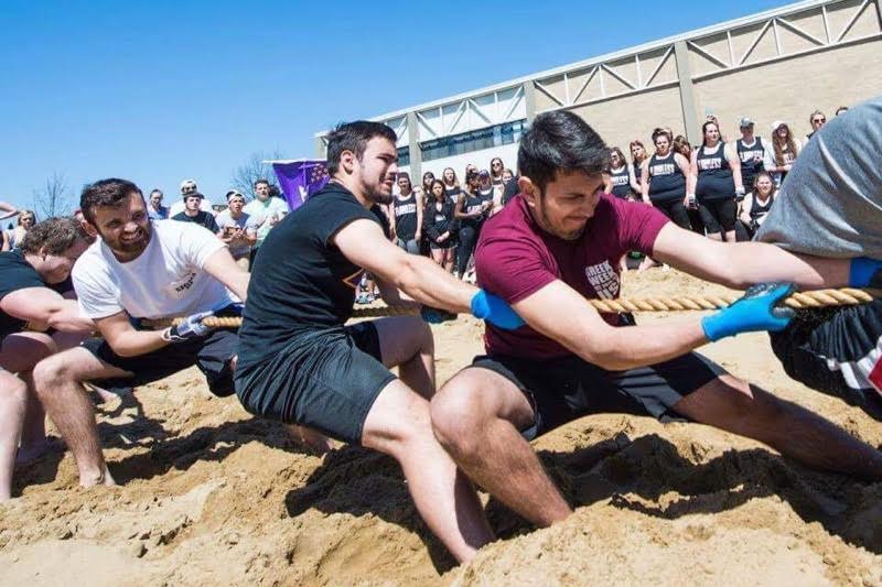 Sigma Pi members Sergio Stroud, Ace Ervick and Cody Likens compete in a tug of war event against other fraternities during Greek Week last semester. Their fraternity received the Grand Chapter Award this summer at Sigma Pi's national Convocation.