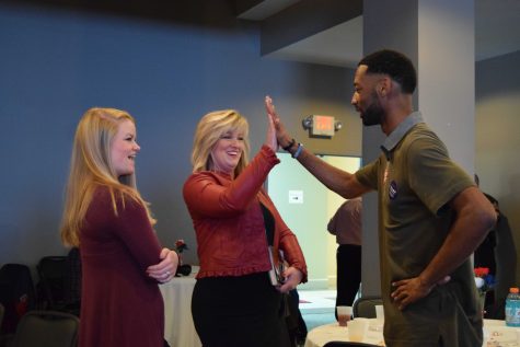 Former USI College Republicans President Donovon Phipps high-fives Holli Sullivan, a confirmed state representative after election night. The two shared a celebratory moment alongside Sullivan’s daughter Savannah as the Republican Party claimed the majority of local election wins.