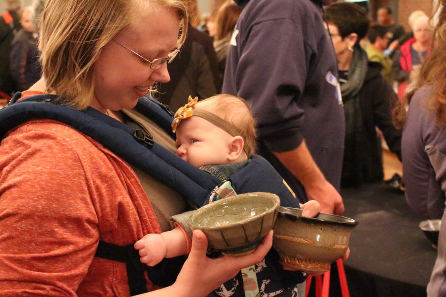 USI alumna, Katie Ewers searches for the perfect “cereal bowl” with her daughter Samantha at Empty Bowls Saturday morning. Ewers said she took Al Holen’s ceramics class last summer and said she would love to do pottery again. “It was a fun class,” Ewers said.