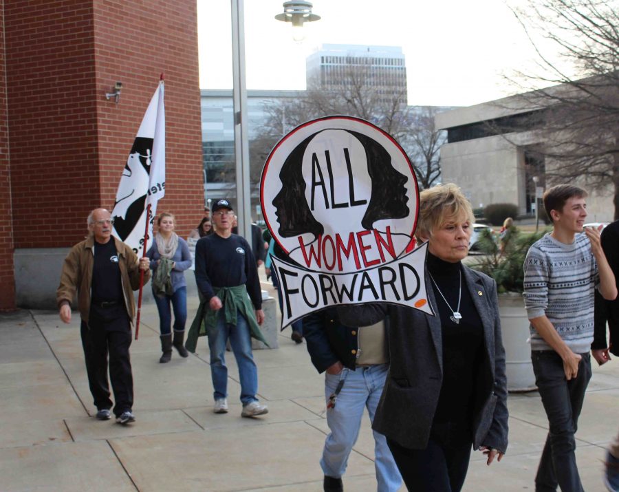 Corliss Chastain, an adjunct in the art department, marches down the street with her friend from high school. "You can't sit at home and bitch about it," she said. 
"You've got to at least act on it in some way."