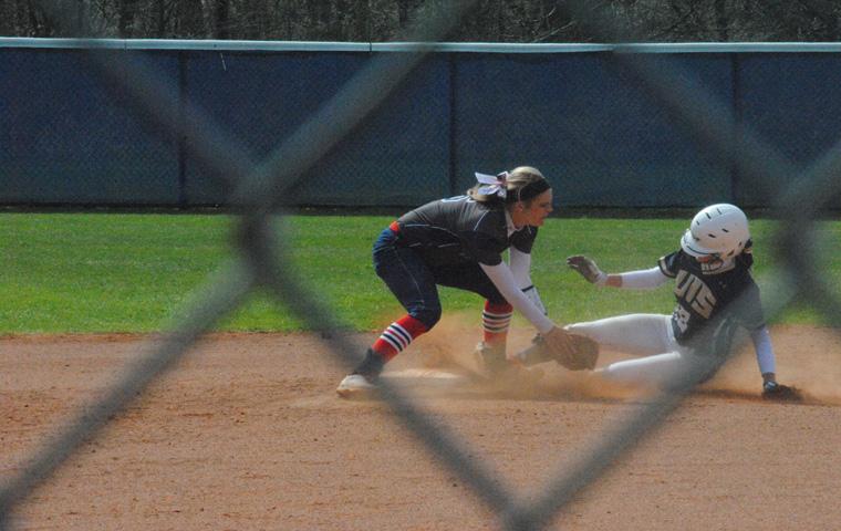 Freshman Lindsey Barr attempts to tag out a member of the University of Illinois Springfield team before she reaches her base during the March 25 game at the USI Softball Field. The infielder/catcher had two RBIs and scored two runs and a home run during the game.