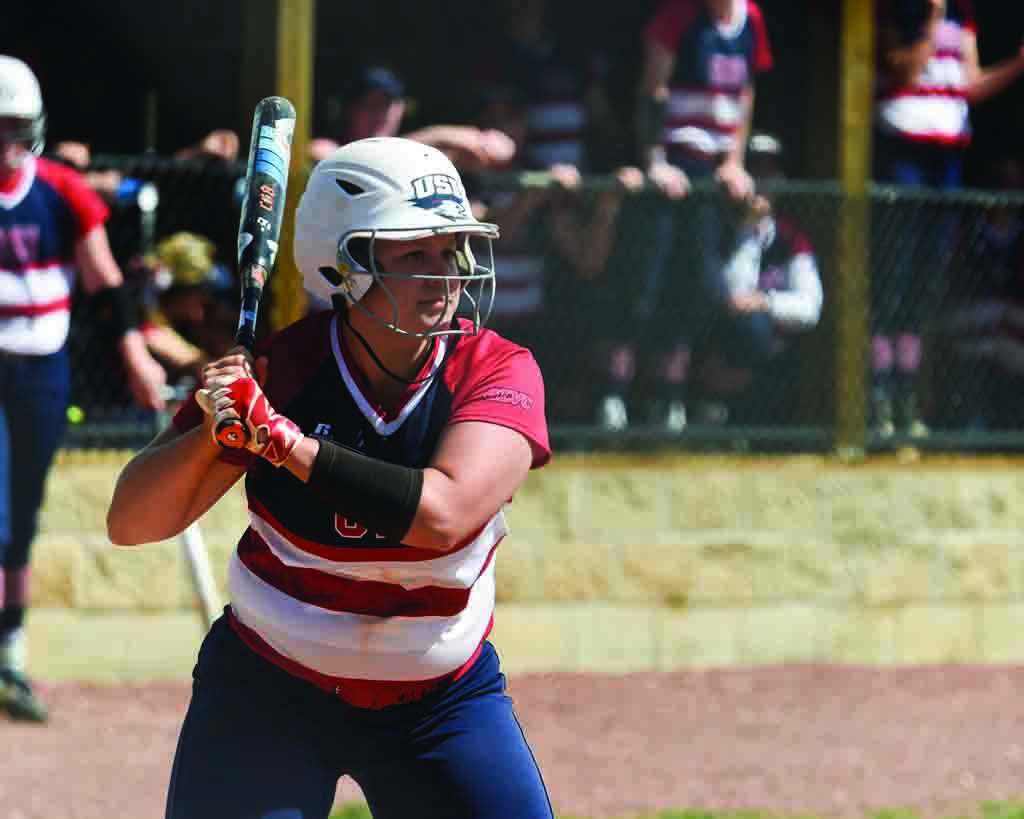 Senior Haley Hodges prepares to swing at an incoming pitch during the team’s Senior Day game. 