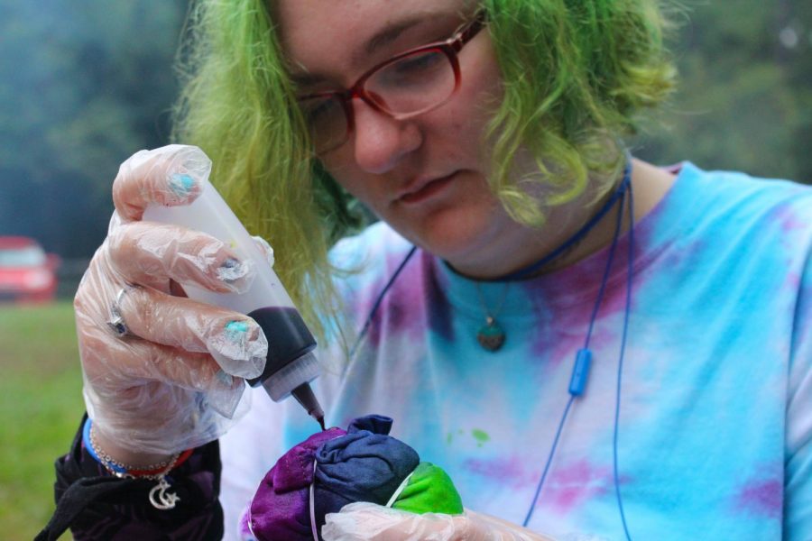 Anika Cunningham, freshman English literature major, participates in tie-dying at the event hosted by SAGA in honor of National Coming Out Day Wednesday evening.  