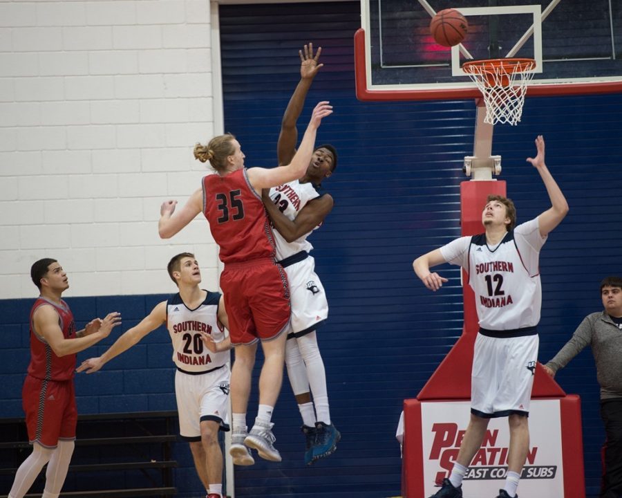 DayJar Dickson (23) goes up for a block as Julius Rajala (12) waits to collect the rebound against William Jewell Jan. 5, 2017.