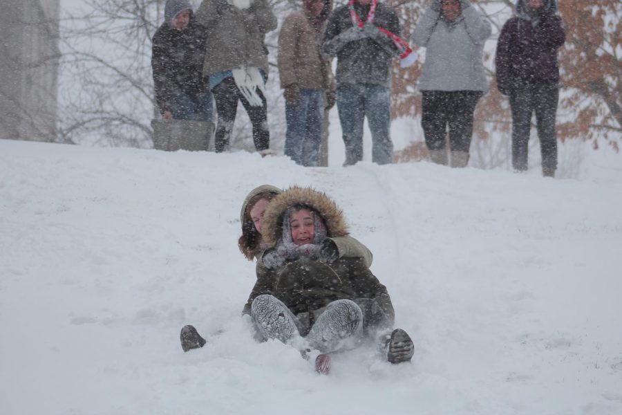 During a snow day on campus, freshmen english Major Emily McClusky and sociology major Emily Shipman sled down a hill located in between the Liberal Arts and the Romain College of Business building during the winter weather on January 12.