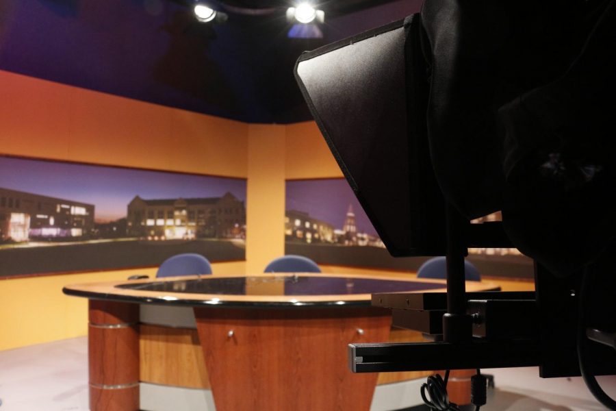 USI graduate Lauren Leslie painted the yellow backdrop that coats the current SETV12 “Access USI” studio more than six years ago.