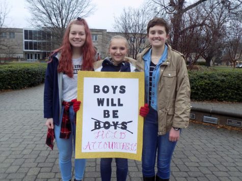 Haley Flamion, freshman journalism major, Erika Uebelhor, freshman political science and pre-law major, and Josi Barscz, freshman biochemistry major smile with their poster Saturday afternoon. 