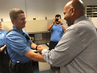 USI President Ron Rochon presents Public Safety Officer Parker Roark with a new badge. The badges are a part of an overhaul of Public Safety apparel.