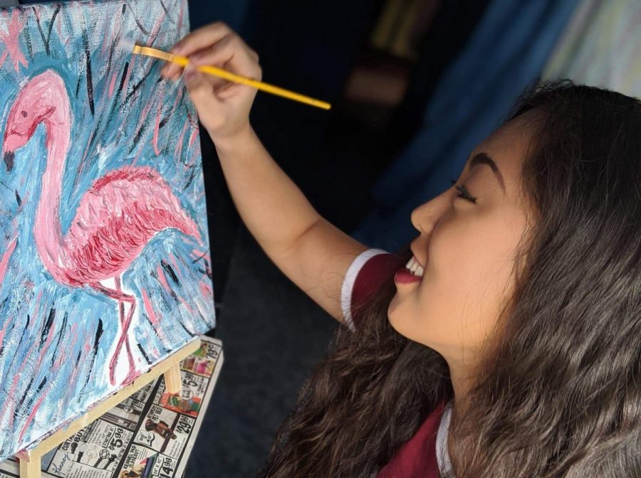 Graduate Cailan Walters paints a flamingo in her room April 4. Walters said she is spending her newly found free time doing new hobbies.