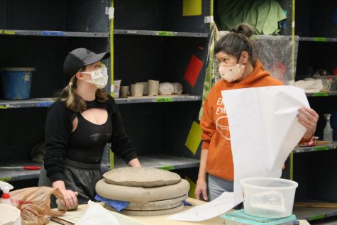 Al Holen helps Ceramics student