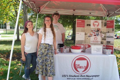 Business Manager, Cobi Schieferstein, Editor-in-Cheif, Shelby Clark and Sports Editor, Pat Baker, stand at The Shields booth during the Fall Student Involvement Fair September 1, 2021.
