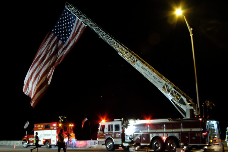 The American Flag is fully raised over the Lloyd Expressway. Over five fire departments took part in the raising of the flag early Saturday morning. This is the first year firefighters plan to have the flag raised for a 24-hour period. 