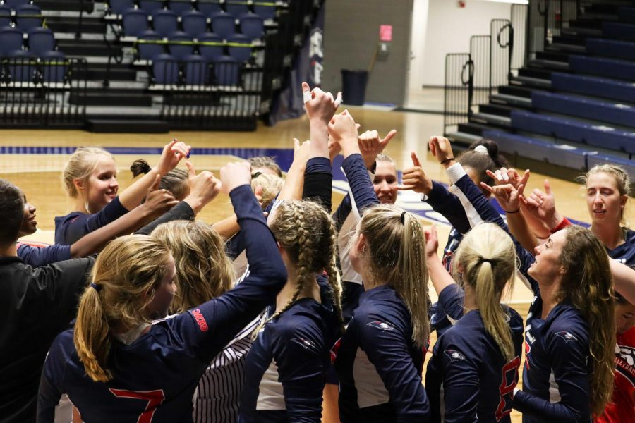 The womens volleyball team gathers after winning the first game of the invitational Thursday. The team won all four of their games in the invitational. 