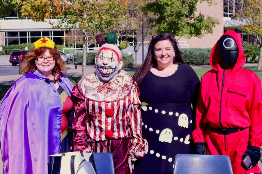 Members of the department of communications stand behind their table in Halloween costumes. (left to right) Leigh Anne Howard, Jane Weatherred, Summer Shelton and Stephanie Young.