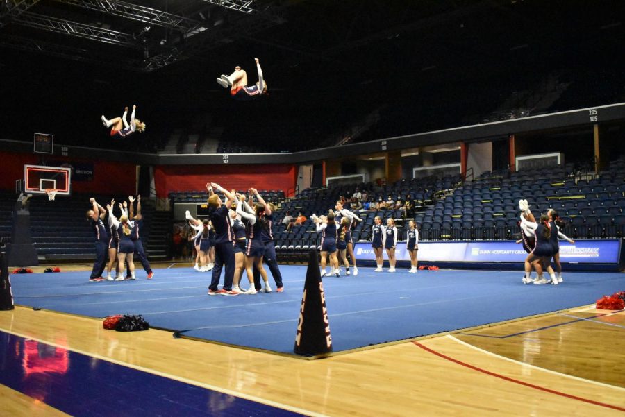The USI Cheer team kicks off the Midnight Madness festivities by performing cheers and stunts for fans Thursday night at the Screaming Eagles Arena.