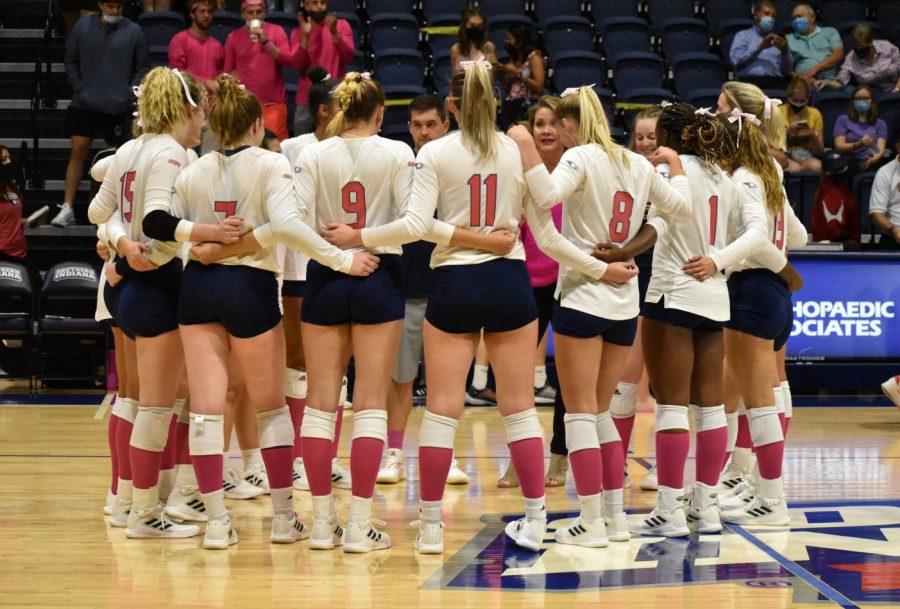 Womens volleyball team wears pink Friday for the Breast Cancer Awareness Match. The players, coaches and fans sported pink for the cause.