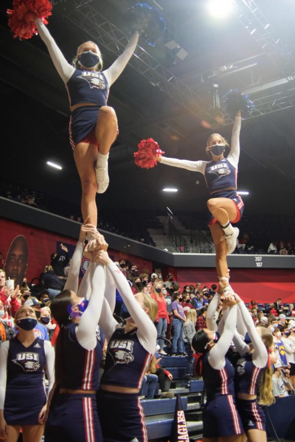 The university cheer team boosts morale in the student section during time out Monday. 