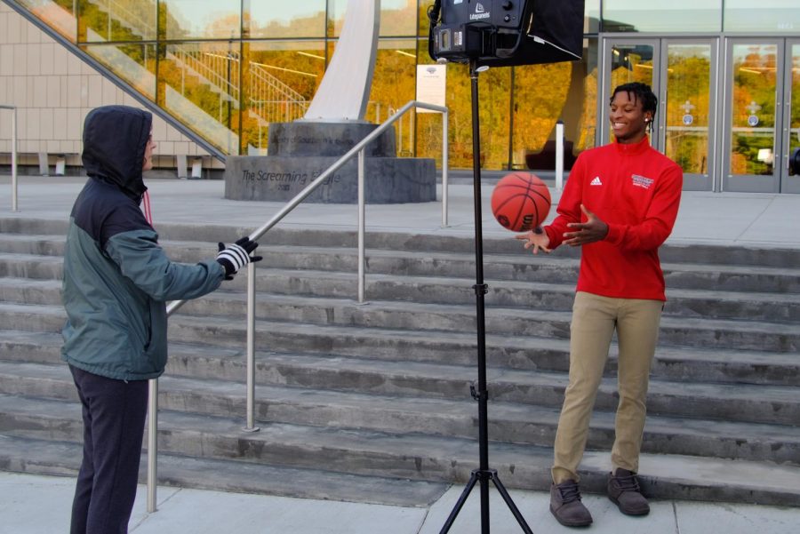 Kindra Strupp tosses a basketball to Tyler Henry while he is filmed for The College Tour.