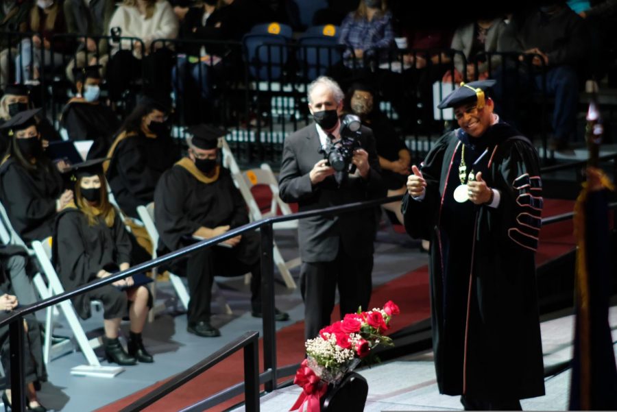 President Rochon gives a thumbs up to graduates that are awaiting to receive their diploma.
