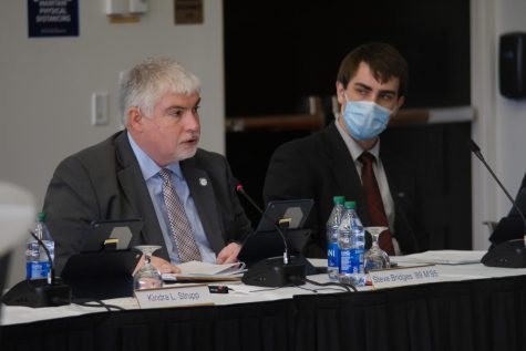 Steven Bridges, treasurer and vice president of finance administration, and Liam Collins, student member of the Board of Trustees, attend a Board of Trustees meeting on Jan. 13, 2022.