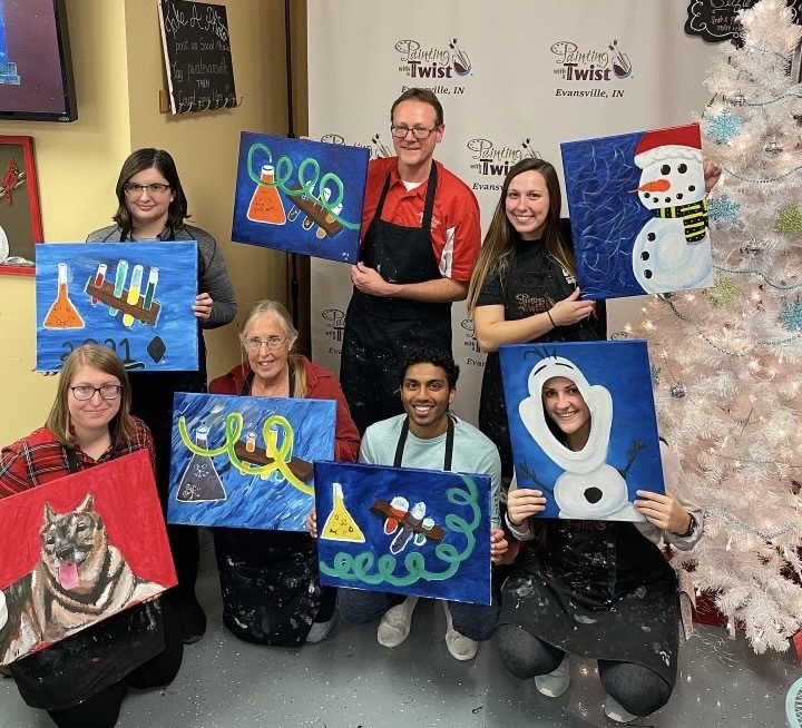 Jeffery Jeff Seyler holds his painting amongst students in the American Chemical Society at Painting with a Twist Dec. 2021. Seyler was the advisor of ACS. 