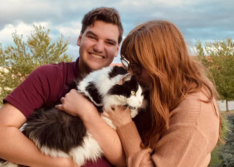 Riley Guerzini and Megan Thorne, two former Editor-in-Chiefs of The Shield, snuggle their Maine Coon cat, Moose. They look forward to raising more cats in the future. 
