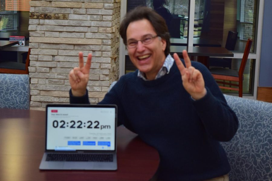 Chad Tew, associate professor of online journalism, celebrates 2:22 p.m. on Feb 22, 2022 in the Traditions Lounge. 