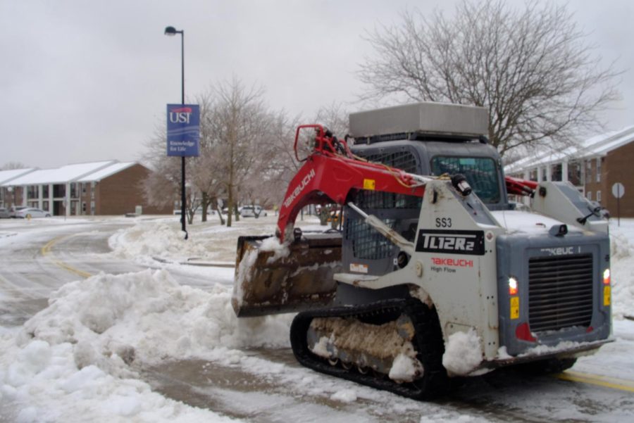 A bulldozer moves snow and ice on ODaniel Laine Feb. 3, 2022. 
