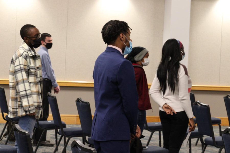 Students stand and sing the Negro National Anthem Tuesday evening. The keynote by Shirval Moore Tuesday was hosted by the Multicultural Center as a part of Black History Month 2022. 